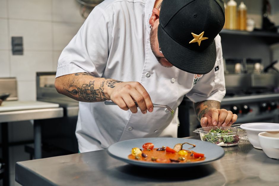 Professional chef carefully plating food for an event
